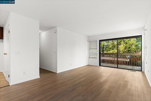 unfurnished room with wood-type flooring