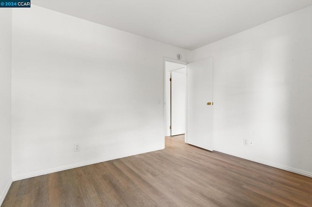 spare room with hardwood / wood-style flooring