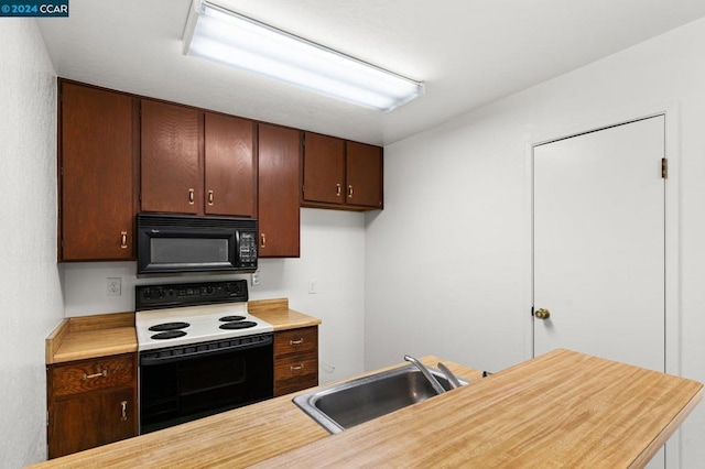 kitchen featuring dark brown cabinets, electric range, and sink