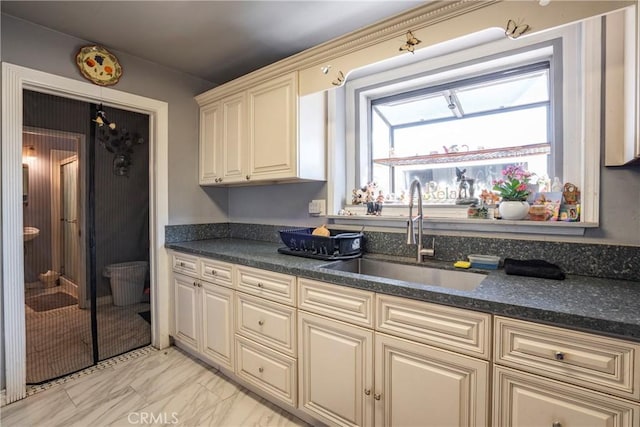 kitchen featuring cream cabinets and sink