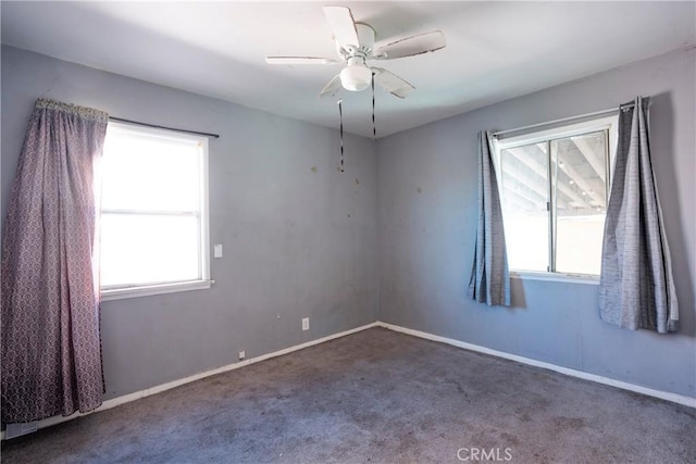 spare room featuring carpet and ceiling fan