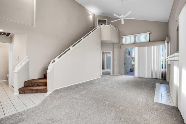 unfurnished living room with ceiling fan, high vaulted ceiling, and light tile patterned floors