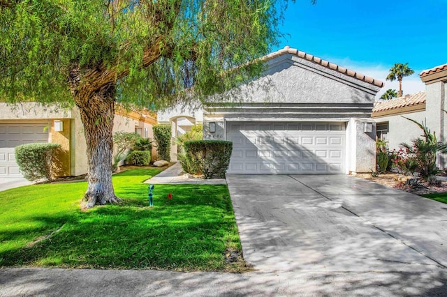 view of front of property with a garage and a front lawn