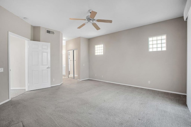 empty room featuring carpet floors and ceiling fan