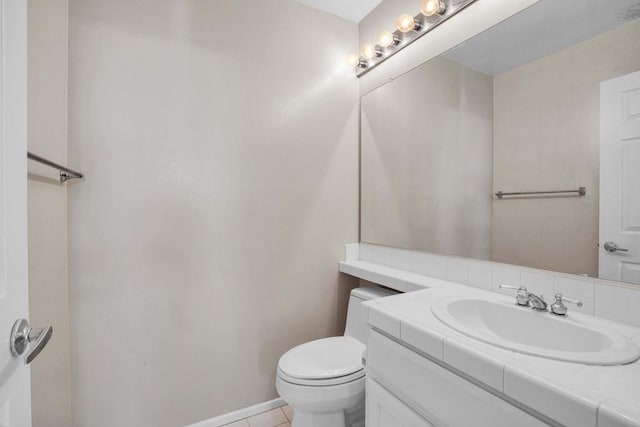 bathroom featuring tile patterned flooring, vanity, and toilet