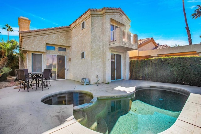 view of swimming pool featuring an in ground hot tub and a patio