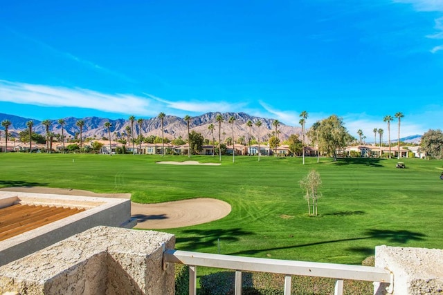 view of home's community with a mountain view and a yard