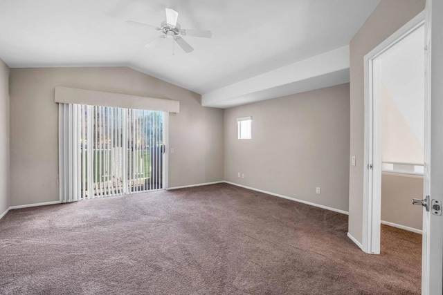 spare room with dark colored carpet, ceiling fan, and lofted ceiling