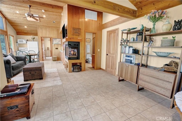 living room with wooden ceiling, light tile patterned floors, and wooden walls