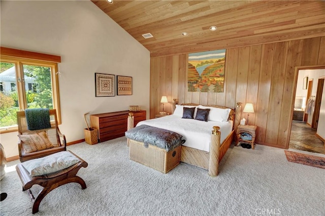 carpeted bedroom with high vaulted ceiling, wood walls, and wood ceiling