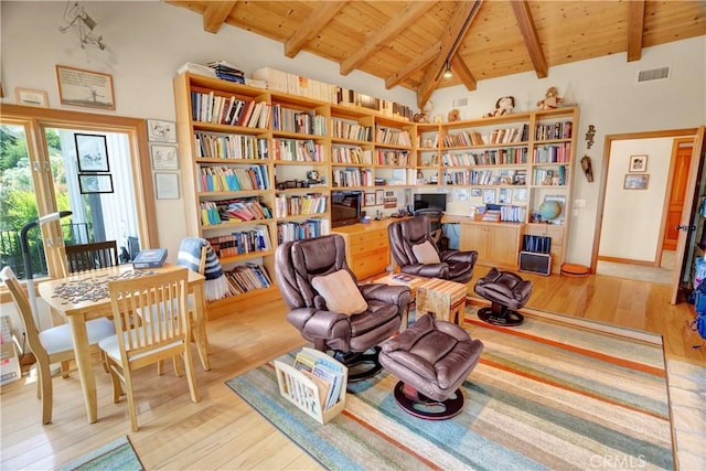 living area with high vaulted ceiling, beamed ceiling, wood ceiling, and light hardwood / wood-style flooring