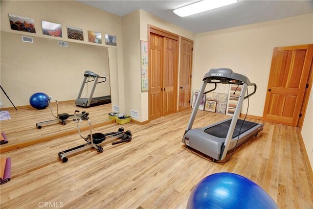 workout area featuring hardwood / wood-style flooring