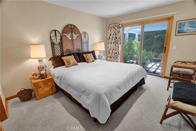 carpeted bedroom featuring access to exterior