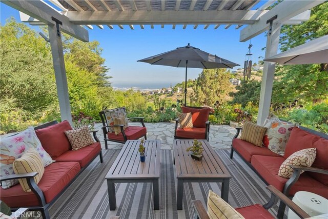 view of patio / terrace featuring an outdoor living space and a pergola