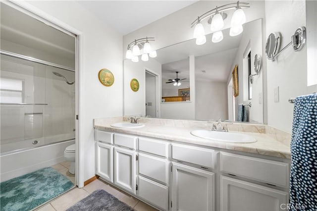 full bathroom with vanity, bath / shower combo with glass door, tile patterned flooring, ceiling fan, and toilet