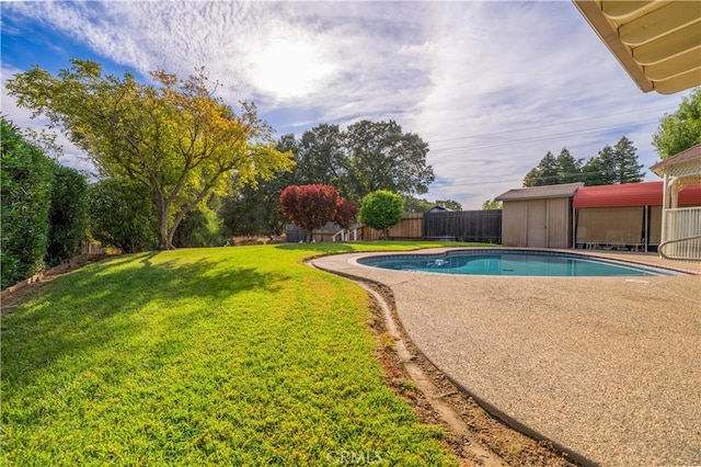 view of swimming pool with a patio, a storage unit, and a lawn