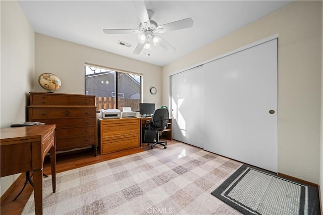 office space with light hardwood / wood-style floors and ceiling fan