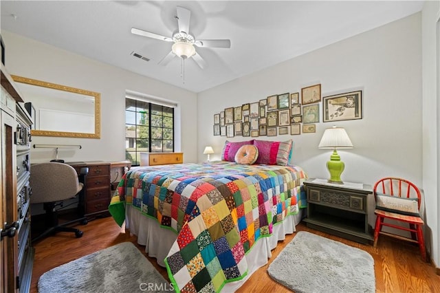 bedroom featuring hardwood / wood-style floors and ceiling fan