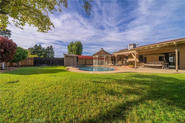 view of yard with a fenced in pool and a patio