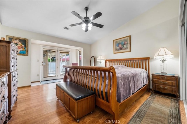 bedroom featuring ceiling fan, vaulted ceiling, access to exterior, and light hardwood / wood-style flooring