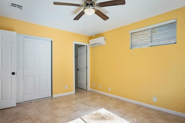 unfurnished bedroom with a wall mounted AC, ceiling fan, and a closet