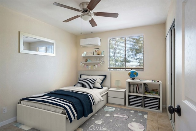 bedroom featuring a wall unit AC, ceiling fan, and light tile patterned flooring