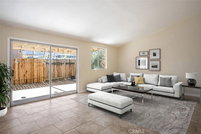 living room with lofted ceiling and light tile patterned flooring