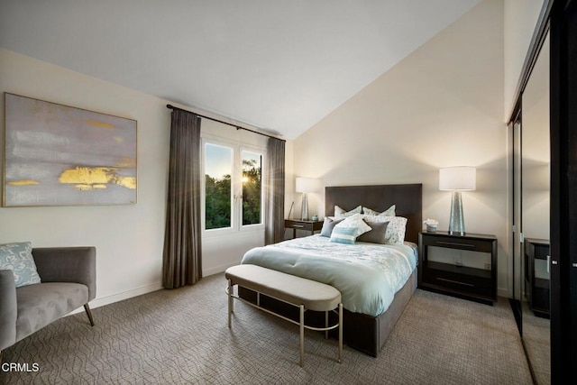 bedroom with carpet floors and vaulted ceiling