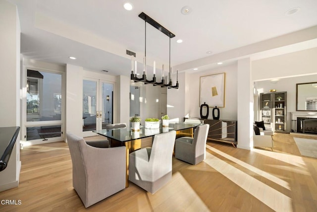 dining space with light hardwood / wood-style floors