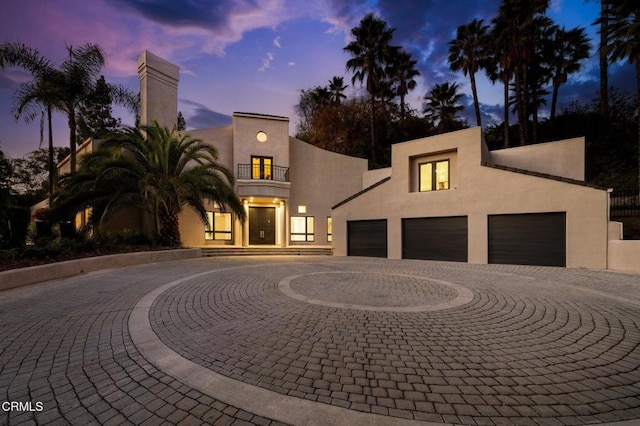 view of front of house featuring a garage and a balcony