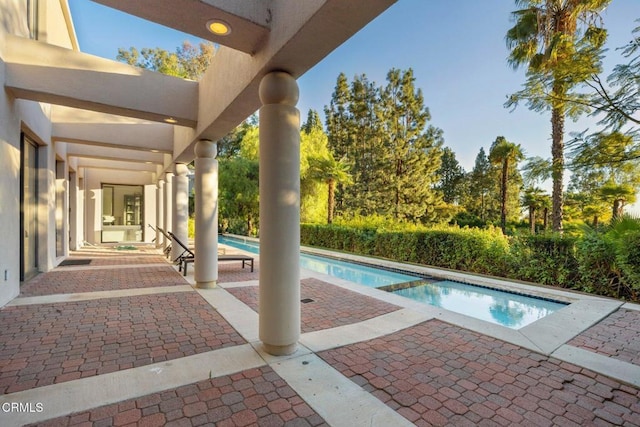 view of swimming pool featuring an in ground hot tub