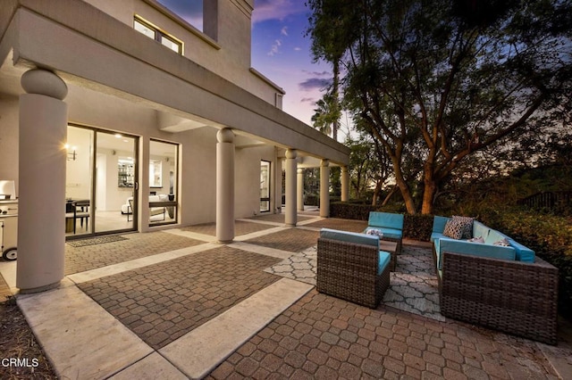 patio terrace at dusk with an outdoor living space