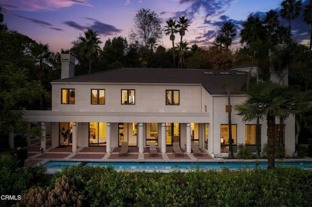 view of back house at dusk