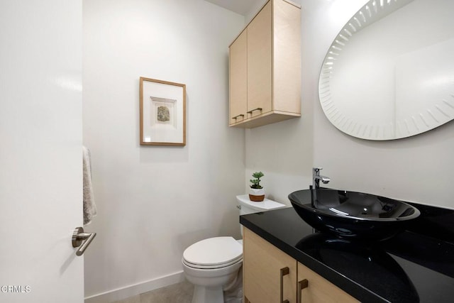 bathroom with tile patterned floors, vanity, and toilet