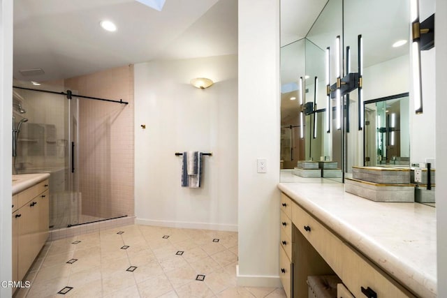 bathroom with tile patterned floors, vanity, and walk in shower