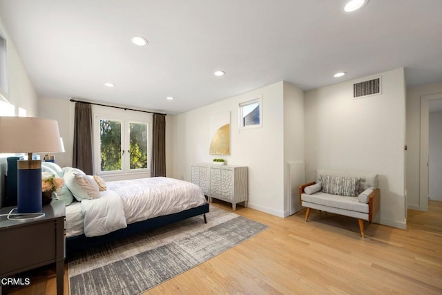 bedroom featuring french doors and light hardwood / wood-style floors