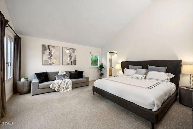 carpeted bedroom featuring high vaulted ceiling