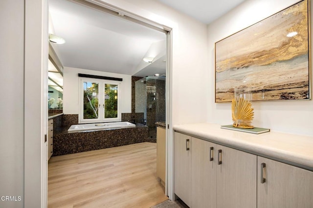 bathroom featuring vanity, shower with separate bathtub, and hardwood / wood-style flooring