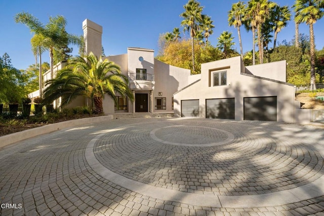 view of front of property with a balcony and a garage