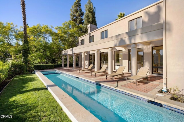 view of swimming pool with a lawn and a patio area