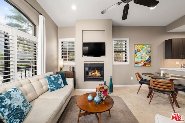 living room featuring ceiling fan and light tile patterned flooring