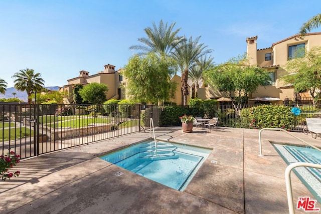 view of pool with a community hot tub and a patio