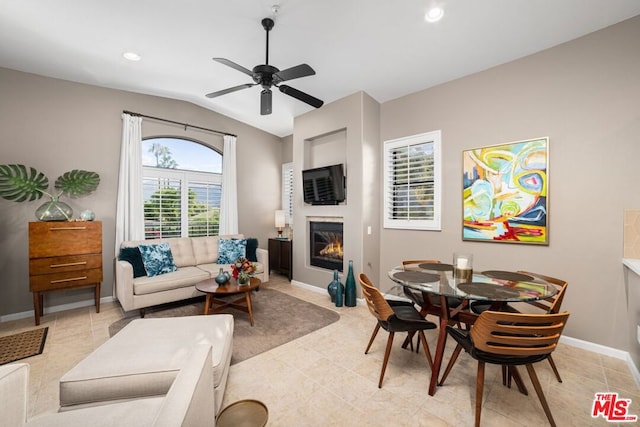 living room featuring light tile patterned floors, ceiling fan, and lofted ceiling