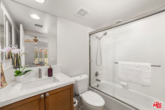 full bathroom featuring vanity, toilet, ceiling fan, and enclosed tub / shower combo