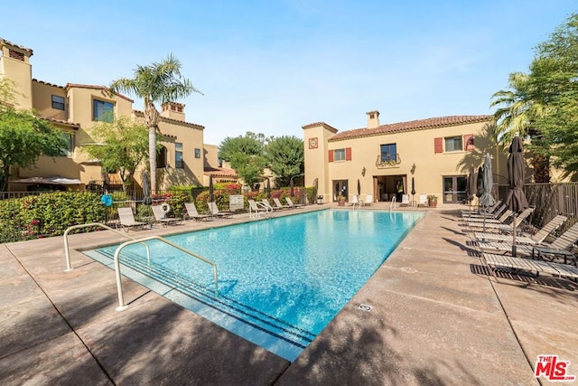 view of swimming pool with a patio