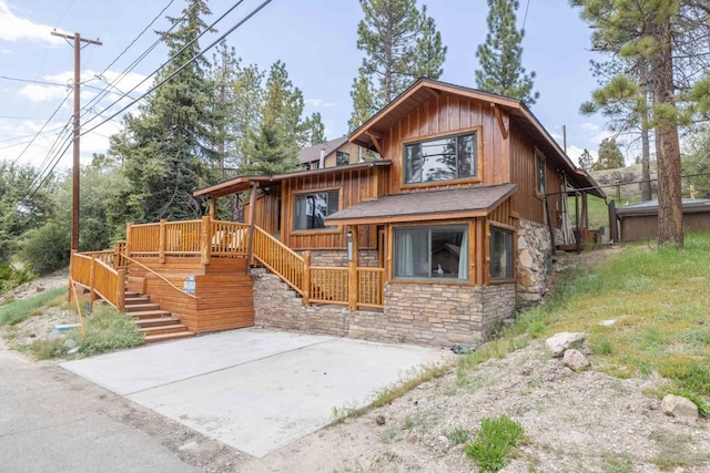 view of front facade with a patio and a wooden deck