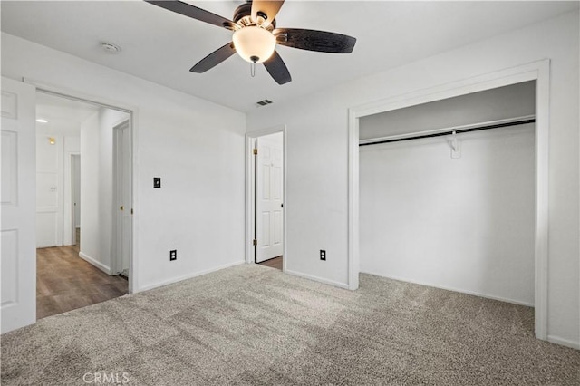 unfurnished bedroom featuring carpet, a closet, and ceiling fan