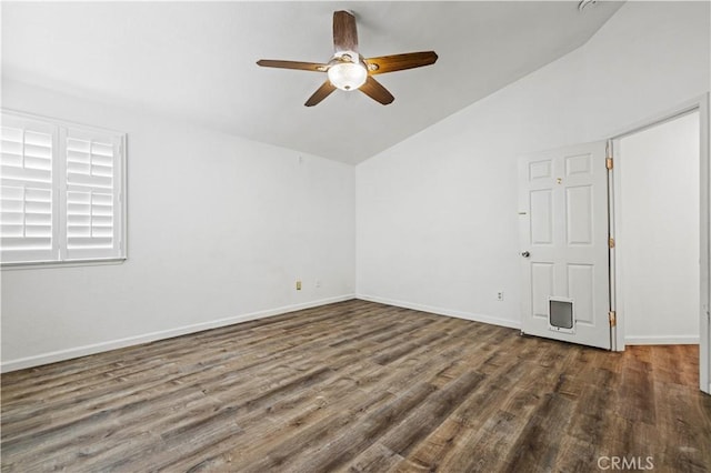 empty room with ceiling fan, dark hardwood / wood-style floors, and vaulted ceiling