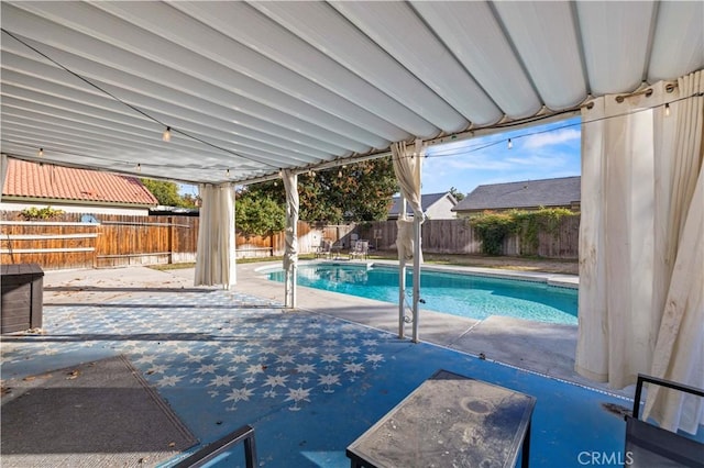 view of swimming pool with a patio