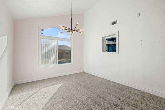 carpeted empty room with vaulted ceiling and a notable chandelier